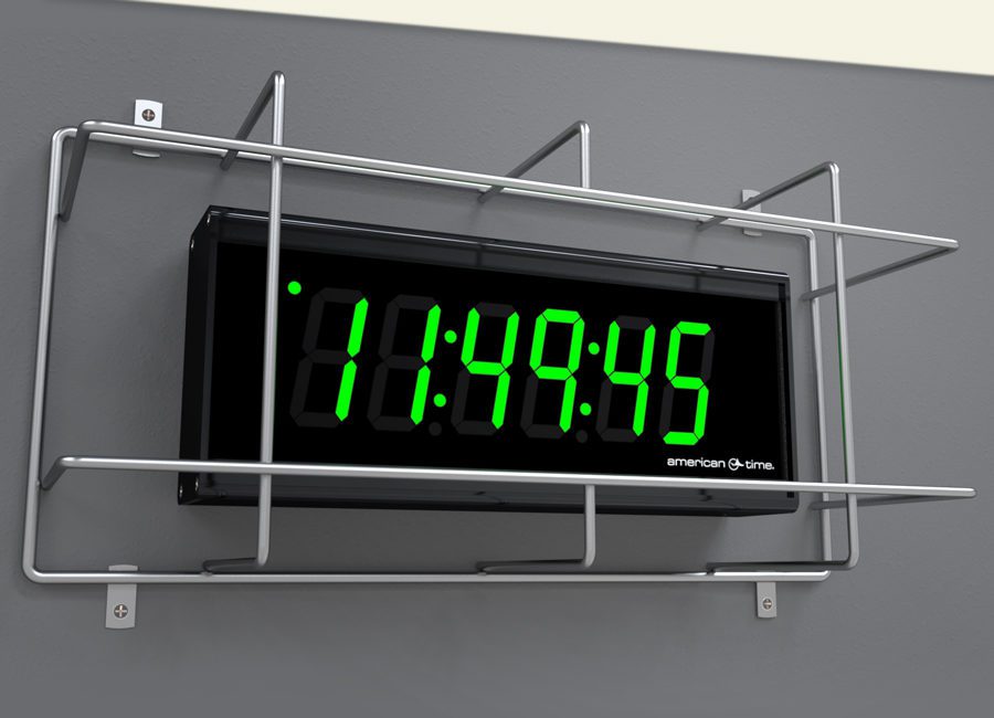 Digital clock on wall with protective guard